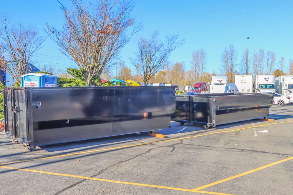 Professional dumpster rental service with roll-off container on residential driveway in Chestnuthill